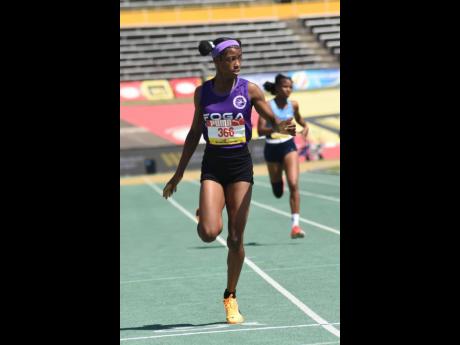 Credit: Ian Allen Shameika McLean of Fogo Road High crossing the line first in her in the Girls’ Class Two 400m at Champs 2026.