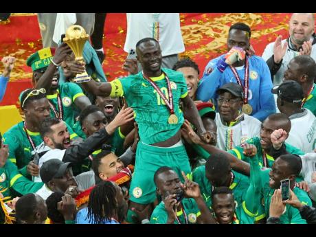 Credit: Youssef Loulidi Senegal's Sadio Mane holds the trophy aloft as he celebrates with teammates after winning the Africa Cup of Nations final football match between Senegal and Morocco in Rabat, Morocco, Sunday, January18, 2026. (AP Photo/Youssef Loulidi, File)