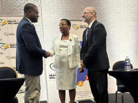 Credit: JIS News Director of the Emergency, Disaster Management and Special Services (EDMSS) Branch at the Ministry of Health and Wellness, Dr Nicole Dawkins-Wright (centre) greets Director General of the Office of Disaster Preparedness and Emergency Management (ODPEM), Co