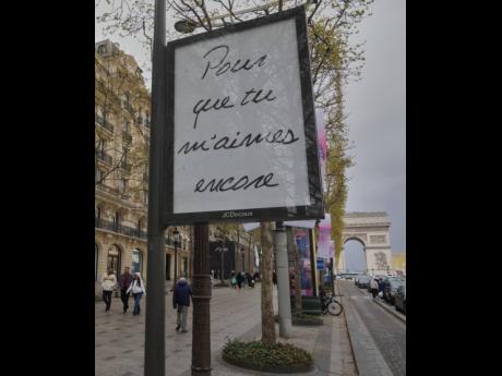 Credit: AP A poster featuring the French title of Celine Dion’s song ‘If That’s What it Takes’, promoting autumn concerts in France on the Champs-Élysées in Paris on Wednesday.