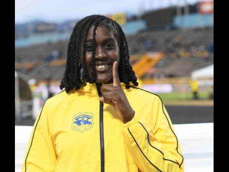 Credit: Antoine Lodge Clarendon College’s Jamelia Young is all smiles after successfully defending her Class 2 shot put title at the ISSA/GraceKennedy Boys and Girls’ Athletics Championships inside the National Stadium yesterday.