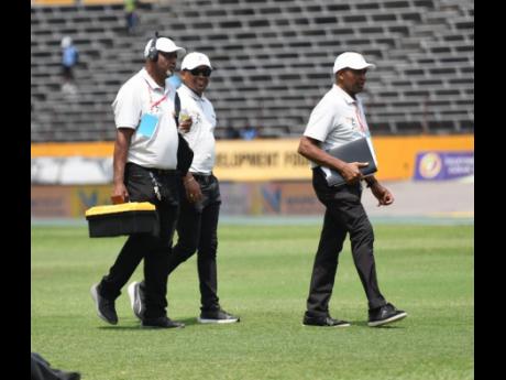 Champs starters at work during the ISSA/GraceKennedy Boys and Girls' Athletics Championships inside the National Stadium, yesterday.