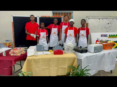 Credit: Contributed St George’s College students pose at a booth showcasing their food-service business at the recently held STGC Teen Biz Expo 2026.