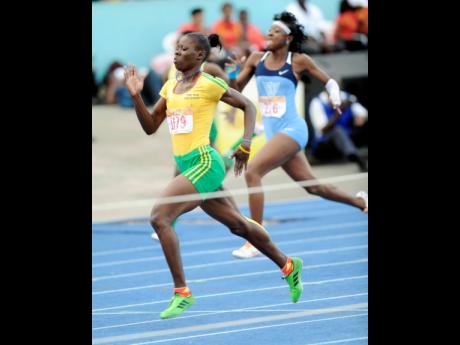 Credit: Ricardo Makyn Shericka Jackson of Vere Technical High wins Class One 200 metres at Champs 2013.