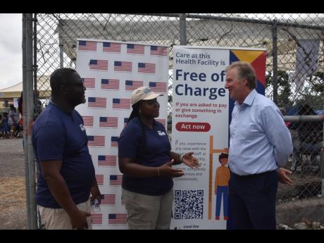 Credit: Photo by Courtney Locke Scott Renner (right), United States Embassy chargé d’affaires in Kingston, is provided with an update on the Hope Mobile Clinic in Barrett Town, St James, by Dr Didinu Tamaklor, country director for Project Hope, and Kamesha Kelly-Swaby, emergency respo