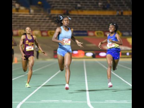 Credit: Ian Allen Kelly Ann Carr (centre) from Edwin Allen High wins the Class One 400 metres in 52.20 seconds on Thursday ahead of Nastassia Fletcher (right) from Hydel High, 52.48 and Abrina Wright (left) of Holmwood Technical who was third in 52.81.