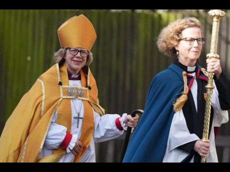 Sarah Mullally, left, arrives for the Enthronement Ceremony installing her as archbishop of Canterbury in Canterbury, England, Wednesday, March 25, 2026, the first woman ever to lead the Church of England.