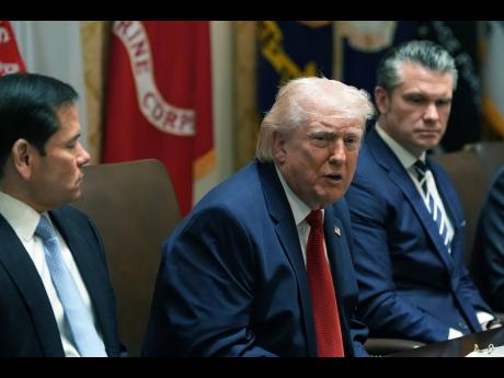 US President Donald Trump speaks during a Cabinet meeting at the White House, in Washington, DC. With him are Secretary of State Marco Rubio (left) and Secretary of Defence Pete Hegseth.