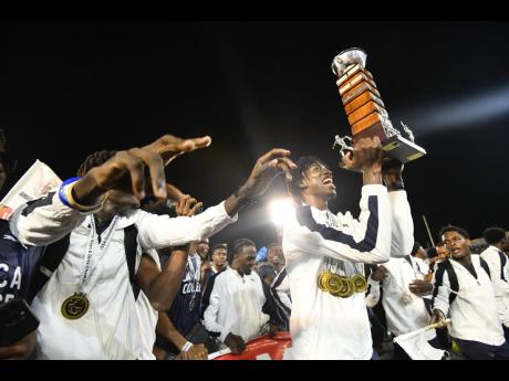 Jamaica College Athletes celebrate winning the ISSA/GraceKennedy Boys and Girls’ Athletics Championships title inside the National Stadium yesterday.