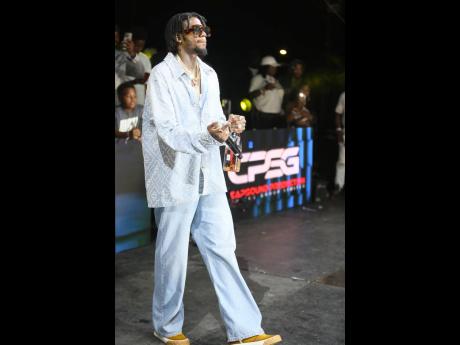 Alkaline hits the stage at the Up to the Line after-Champs Party at the Police Officers’ Club in St Andrew on Sunday morning. 