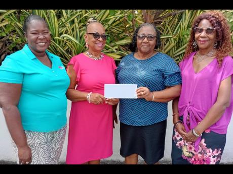 Vana Taylor (second left), chairman of the Jamaica Hotel and Tourist Association Ocho Rios Runaway Bay Chapter, hands over a cheque for $150,000 to Gwendolyn Howell, administrator at Widow’s Mite, as an annual charitable donation, while Cherile Thompson 