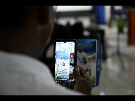 Credit: Ricardo Makyn/Chief Photo Editor A mourner at yesterday’s funeral for Kiero Pinnock at the Regent Street Seventh-day Adventist Church in Kingston.