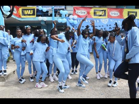 Members of Edwin Allen High’s female track team dance up a storm as they celebrate their victory in the ISSA/GraceKennedy Girls’ Athletics Championships in Frankfield, Clarendon, on Monday.