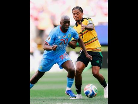 Jamaica's Leon Bailey (right) and Yoane Wissa of the Democratic Republic of Congo (DR Congo) battle for the ball during an Inter-continental World Cup playoff final in Guadalajara, Mexico. 