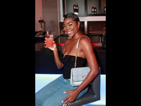 Alicia Sewell is every bit alluring in an off-the-shoulder top paired with jeans.