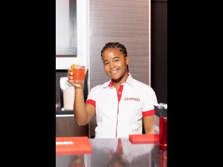 Shanice Mitchell, brand activator, Campari Group, raises a cocktail in hand at the lyme and mixology experience.