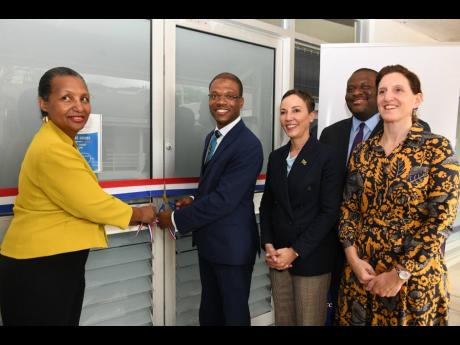 Credit: Contributed Mylène Ferriera (left), president, Alliance Française de la Jamaïque, and Dr Kevin Brown (second left), president, University of Technology, Jamaica, cut the ribbon to officially open the new offices of the Alliance Française at the Technology Innovati