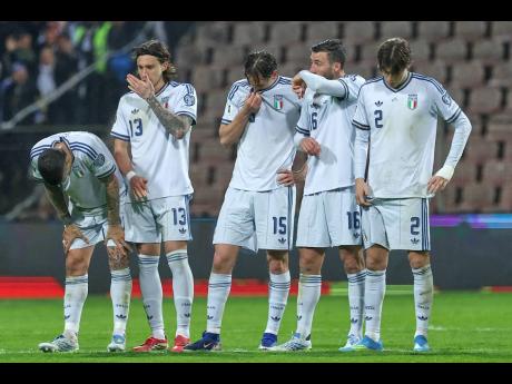 Italy’s players react during a penalty shoot-out during the World Cup qualifying playoff final football match against Bosnia and Italy in Zenica, Bosnia, yesterday.
