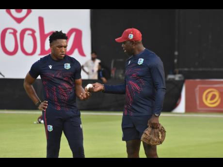 West Indies fast bowling consultant Ottis Gibson (right) gives instruction to fast bowler Jediah Blades during a series against Nepal in Sharjah in September 2025.