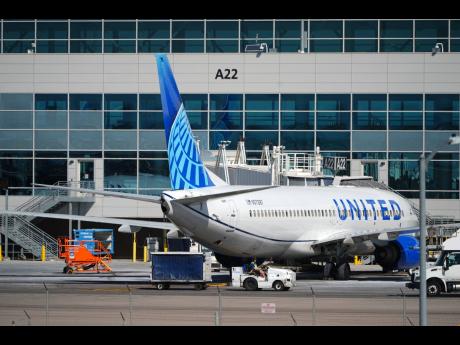 A United Airlines jetliner sits at a gate along the A concourse of Denver International Airport, March 20, 2026, in Denver. (AP Photo/David Zalubowski, File)