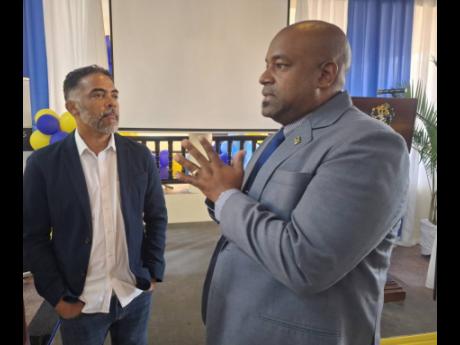 Credit: Albert Ferguson photo Jason Russell (left), president of the Montego Bay Chamber of Commerce and Industry, and Dwight Crawford, deputy mayor of Montego Bay, in conversation during the University of Technology, Western Jamaica Campus School of Business Administration annual semi