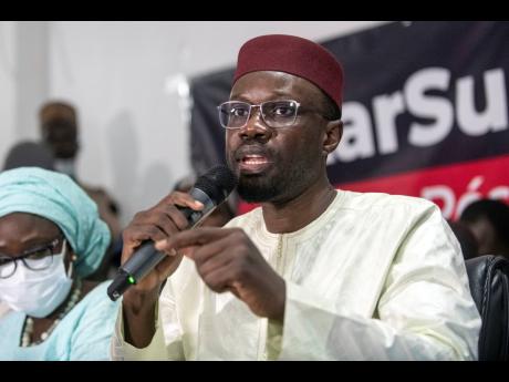 Credit: Sylvain Cherkaoui Senegalese opposition leader Ousmane Sonko addresses journalists following his release from police custody in Dakar, Senegal, on March 8, 2021. (AP Photo/Sylvain Cherkaoui, File)