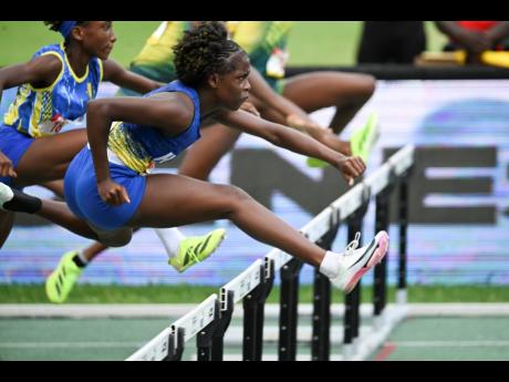Ricardo Makyn/Chief Photo Editor
Hydel High School’s Keneisha Robinson hurdles on her way to winning the Class Four 70-metre hurdles at the ISSA/GraceeKennedy Boys and Girls’ Athletics Championships inside the National Stadium on March 28. 