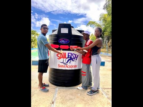 From left:  Suraj Guwalani, coach Eric Raul Urdaneta, and Shreya Guwalani during a ribbon-cutting ceremony for the presentation of a 600-gallon  tank to the SailFish Swim Academy in Tucker, St James, on Saturday, March 28.