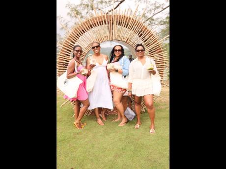 Credit: Contributed Checking in for Porti Village with their welcome bags and coconuts in hand are (from left) Attorney Kelisha Shaw; Medical Office Assistant Trisha Edwards; Principal Moneque McKoy; and Software Engineer Manager Lackeisha Lewis.