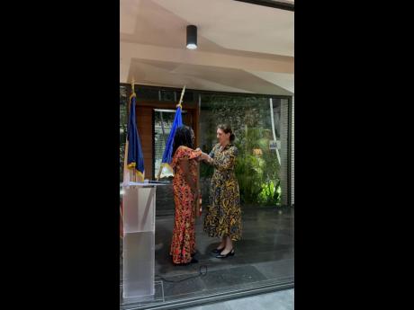 Shelley Wong, receiving her award from Marianne Ziss, ambassador of France to Jamaica. 