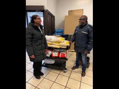 Broughton (left) in conversation with David Betty, president of the Jamaican Canadian Association in Ontario at a Hurricane Melissa donation relief drop-off centre last November. JN Bank in Canada served as the official drop-off for items collected in Toro