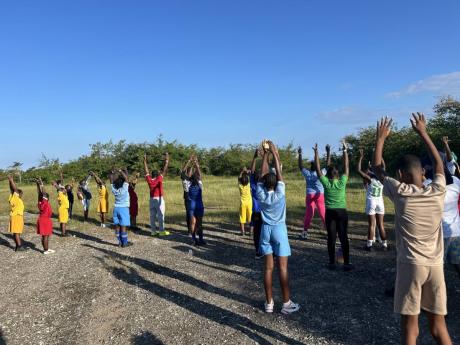 Sheffield Primary students participate in a cool‑down exercise following the 2K walk/run. 