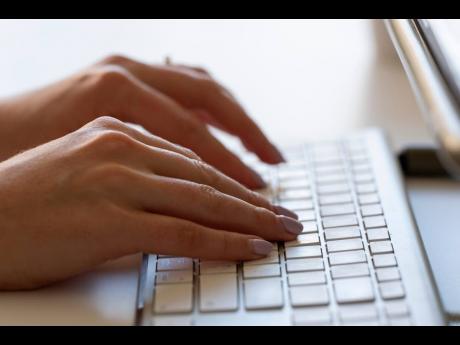 A person types on a keyboard on June 6, 2024, in Portland, Ore. (AP Photo/Jenny Kane, File)