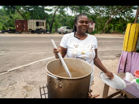 Sean Blake, who runs a cookshop at Gutters, received a stove and other inputs to restart her business.